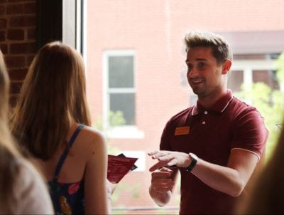 Bumpers College student recruiter Dausen Duncan speaking to a prospective student and parent at a 2019 University of Arkansas recruitment event in Broken Arrow, Oklahoma.